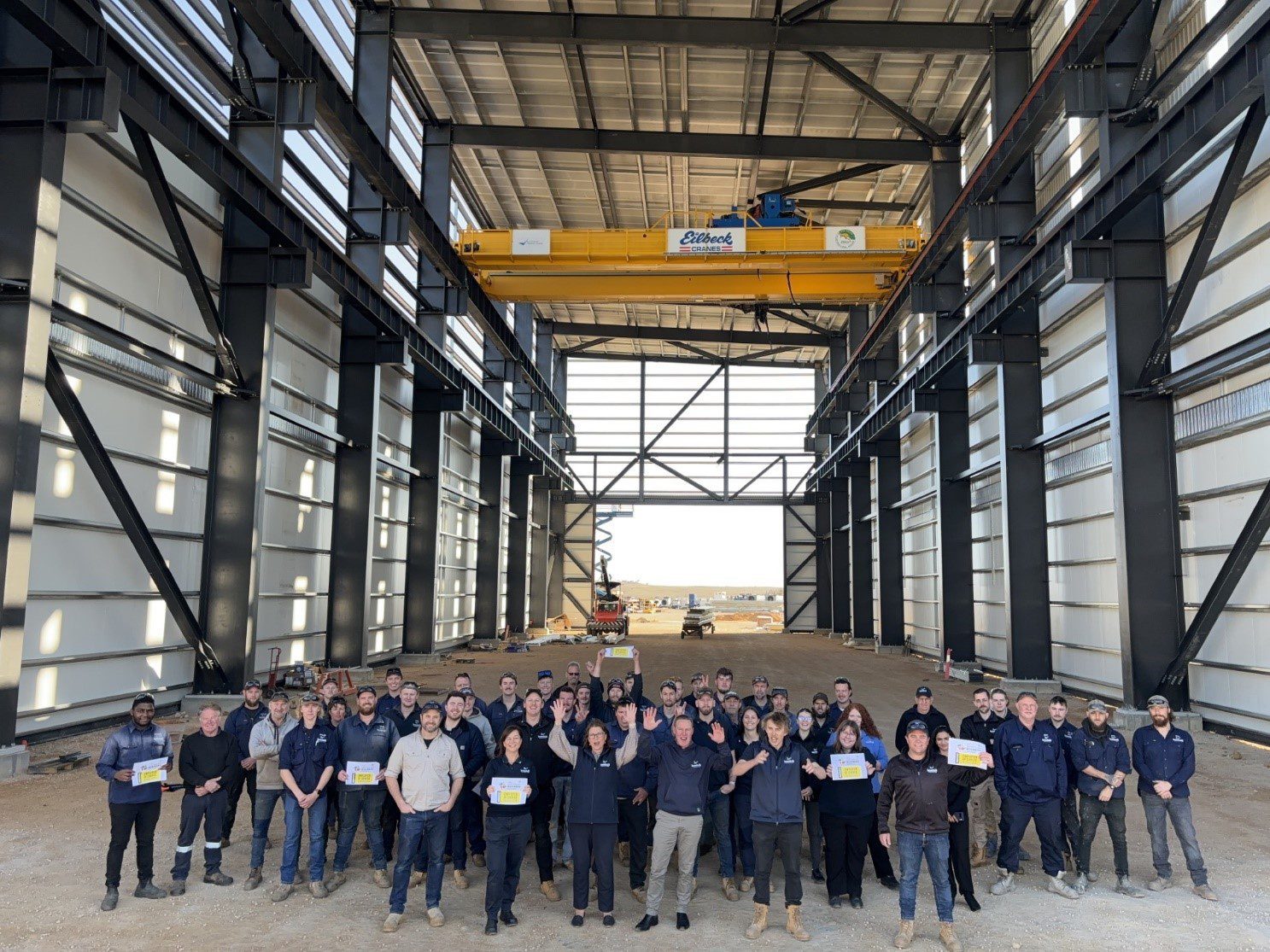 Figure 5: Photo above shows only the 100t crane, there are 2 more 30t cranes to be installed on the lower-level runway beams all of these cranes can service the entire floor area of the building. Building is 70m long, 23m wide and 23m tall. Figure 5: Photo above shows only the 100t crane, there are 2 more 30t cranes to be installed on the lower-level runway beams all of these cranes can service the entire floor area of the building. Building is 70m long, 23m wide and 23m tall.